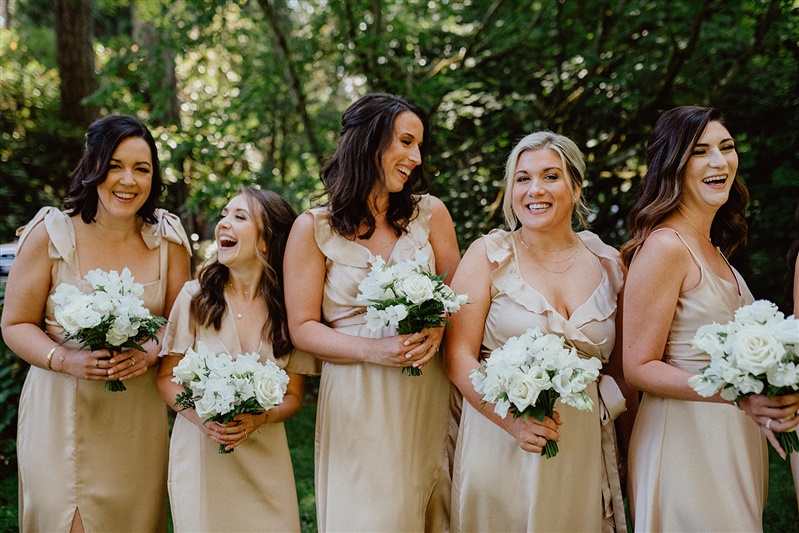 white bridesmaids bouquets and champagne dresses