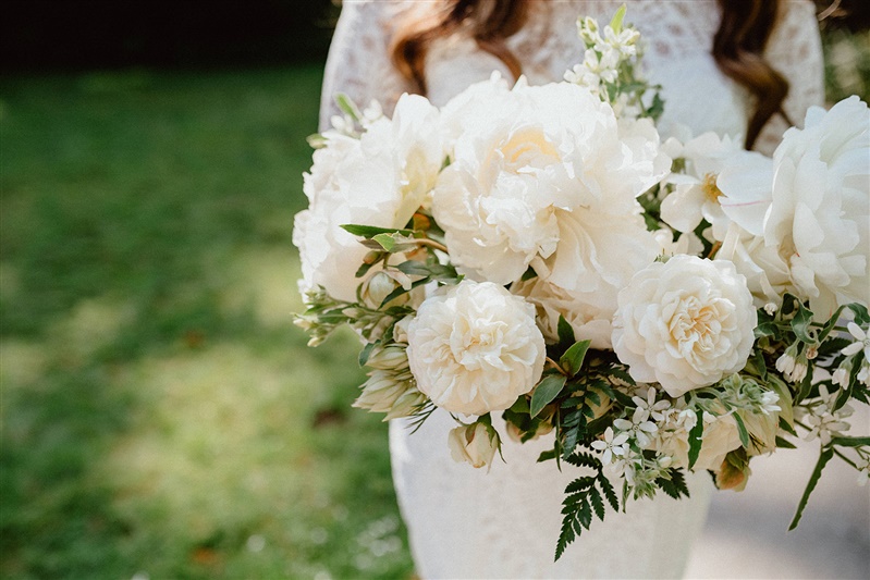 white brides bouquet made from peonies and garden roses
