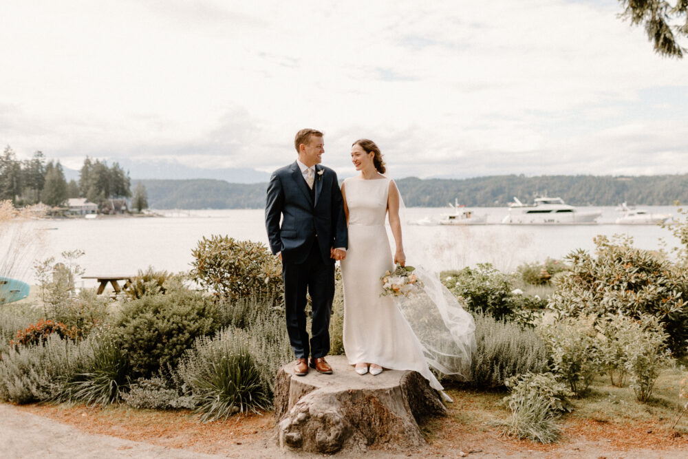 Bride and groom pose for a photo at Alderbrook lodge